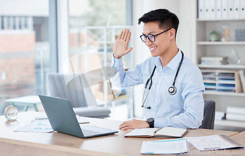 Image of Medical, video call and telehealth with an asian man doctor in his office at the hospital for remote consulting. Healthcare, virtual and wave with a young male medicine professional working online