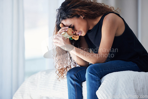 Image of Crying, depression and woman with teddy bear on bed for grief, miscarriage or mourning death of kid. Sad mother, tears and person in bedroom with pain, anxiety or trauma problem, stress or frustrated
