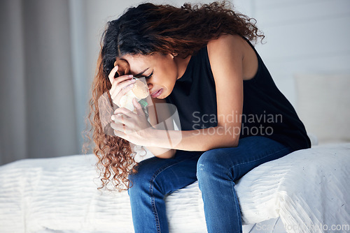 Image of Depression, tears and woman with teddy bear in bedroom for grief, miscarriage or mourning death of kid. Sad mother, crying and person with pain, anxiety or trauma problem, stress or frustrated on bed