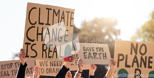 Image of Protest, climate change and poster with a group of people outdoor at a rally or march for conservation. Global warming, freedom and environment with a crowd walking together during a community strike