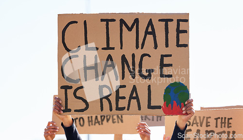 Image of Protest, climate change and sign with a group of people outdoor at a rally or march for conservation. Global warming, freedom and environmental with a crowd walking together during a community strike