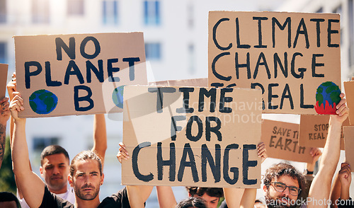 Image of Group, poster and together in street for planet, climate change and sustainable future in city. People, cardboard sign and activism for change, sustainability or justice for environment in metro road