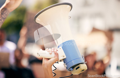 Image of Hand, megaphone closeup and outdoor protest for change, justice or environment for people together in city. Bullhorn, loudspeaker and zoom for communication, speech or leadership for politics on road