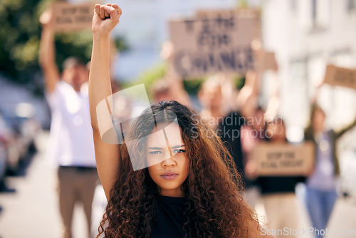 Image of Woman, fist and portrait with protest crowd in street for planet, climate change or sustainable future. Girl, leadership and rally for earth, sustainability or justice for environment in metro road