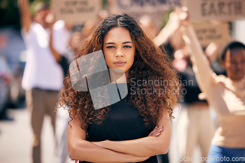 Image of Woman, arms crossed and protest crowd in street for planet, climate change or sustainable future. Girl, leadership portrait or rally for earth, sustainability or justice for environment in metro road