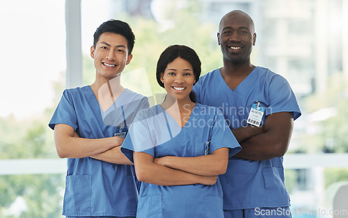 Image of Confidence, crossed arms and portrait of team of doctors standing in the hallway of hospital. Happy, diversity and group of professional medical workers with smile in collaboration at medicare clinic