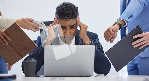 Image of Headache, burnout and overwhelmed businessman surrounded in busy office with stress, paperwork and laptop. Frustrated, overworked and tired employee with anxiety from deadline time pressure crisis.