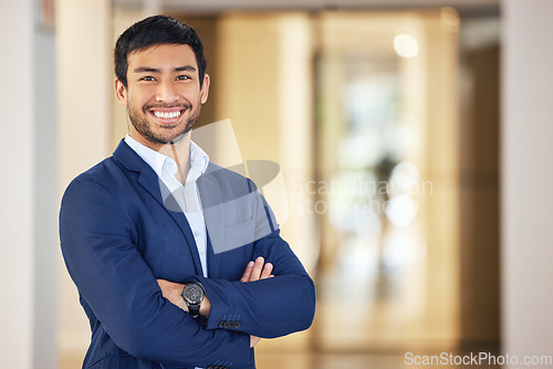 Image of Confident, portrait and a businessman with arms crossed for corporate company, job and professional career. Happy, suit and a young Asian employee with a smile, pride and happiness at the office