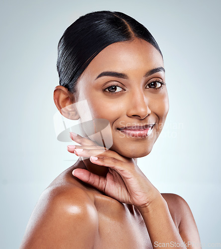 Image of Smile, beauty and Indian woman or model with skincare cosmetic isolated in a studio white background. Clean, natural and portrait of female person hand on her face happy for self love or care