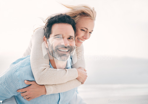 Image of Beach, piggyback and portrait of couple with smile on holiday, vacation and weekend for anniversary. Love, marriage and happy mature man carry woman for bonding, quality time and happiness by ocean