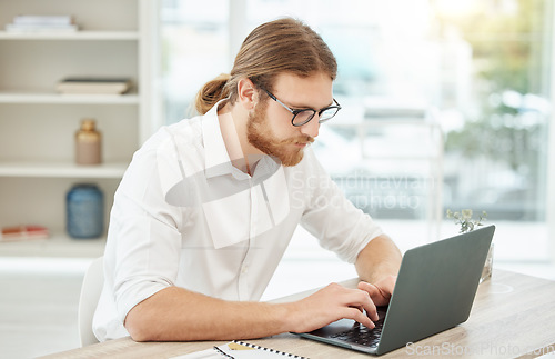 Image of Typing, computer and business man in office for copywriting, company newsletter and research article or blog. Focus, working and social media writer, editor or person at startup, online and laptop