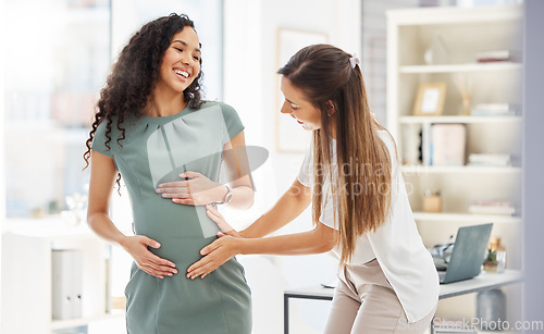 Image of Happy, woman visit her pregnant friend and in a office of their modern workplace with a lens flare. Baby care or healthcare wellness, happiness and friends together at workstation with stomach growth