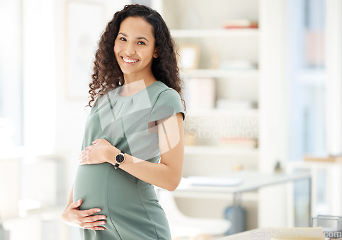 Image of Portrait, smile and a pregnant business woman in her office getting ready for maternity leave from work. Happy, mother and proud with a young female employee holding her stomach in the workplace