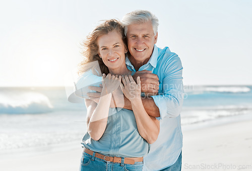 Image of Senior, couple and portrait hug at the beach for happiness and bond in the outdoor. Mature, man and woman holding one another at the ocean with smile and love for vacation and travel in summer