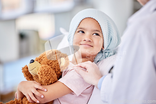 Image of Cancer patient, child and doctor with support, healthcare service and hand for empathy, love and healing in hospital bed. Happy, sick girl or kid listening to pediatrician or medical person helping