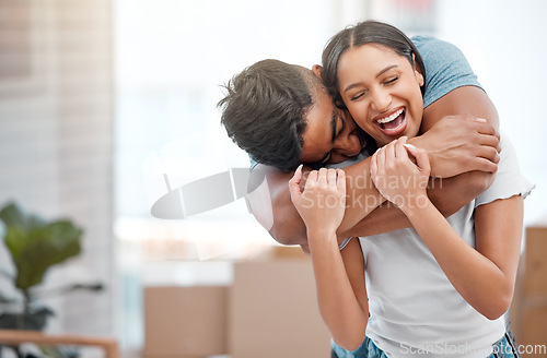 Image of Hug, love and couple laugh in new home excited for property, apartment and real estate investment, Relationship, house and man and woman embrace, laughing and happy in living room on moving day