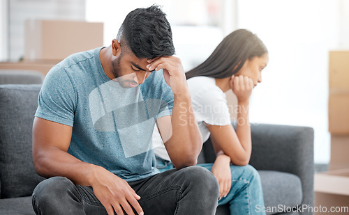 Image of Couple, fight and break up of man feeling depressed on living room sofa with relationship problem. Divorce talk, cheating anxiety and marriage crisis of young people on lounge couch at home thinking