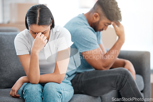 Image of Couple, marriage fight and woman feeling sad and depressed on living room sofa with relationship problem. Divorce talk, cheating anxiety and crisis of young people on a lounge couch at home thinking