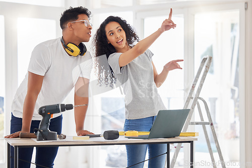 Image of Laptop, renovation and planning with a couple in their new home together for a remodeling project. Construction, real estate or diy property improvement with a man and woman talking in their house