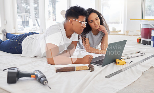 Image of Laptop, thinking and renovation a couple in their new home together for a remodeling project. Construction, real estate or diy property maintenance with a man and woman planning in their house