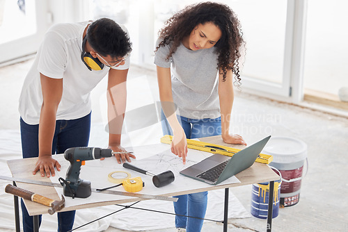 Image of Maintenance, renovation and blueprint with a couple in their new home together for a remodeling project. Construction, real estate or diy property improvement with a man and woman planning in a house