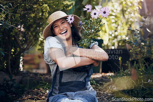 Image of Florist woman, garden and flowers in nursery, smile and hug plant with excited face for sustainable small business. Girl, entrepreneur and love for plants, growth and nature with happiness in spring