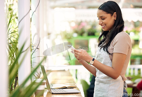 Image of Happy, planning and a woman with a phone at a nursery for orders, business app or stock email. Smile, contact and a young florist with a mobile for social media, work management and connection