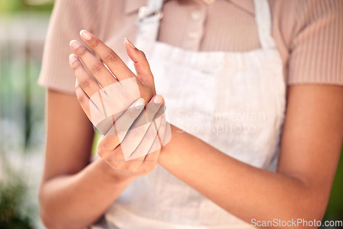 Image of Wrist pain, woman hands and closeup for working in nursery, small business and gardening with problem. Girl, entrepreneur and arthritis in shop, store and joint injury with burnout in workplace