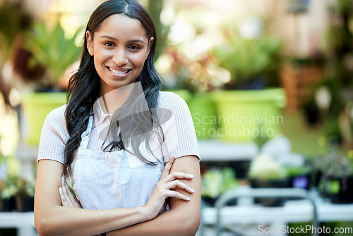 Image of Arms crossed, pride and portrait of woman in a garden or nursery as a business owner or employee. Smile, plant expert and a worker at an ecology shop in a park with mockup space for retail or service