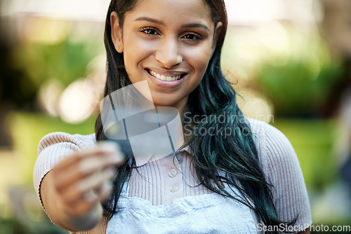 Image of Portrait, woman and entrepreneur with smile, outdoor and banking with apron, shopping or budget. Portrait, female person or business owner with ecommerce, budget or credit card with discount and deal