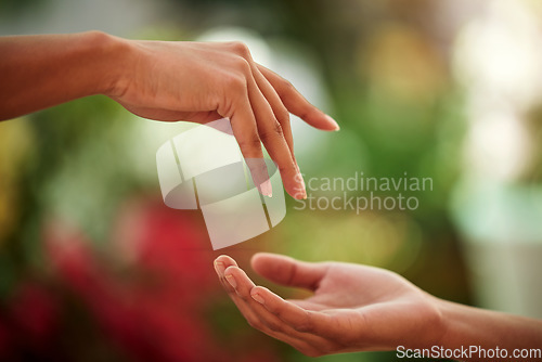 Image of Hands, love and people with a reaching gesture in an outdoor green garden or park in nature. Connection, romantic and closeup zoom of a couple for support, romance or touch together outside.