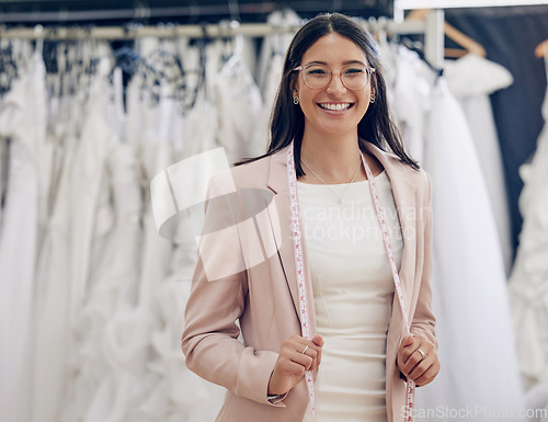 Image of Happy, portrait of woman seamstress working and in a bridal boutique with measuring tape. Retail store, fashion and cheerful or excited female person at work with measurements at dress shop.
