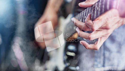 Image of Guitar, stage and man hands at music festival show playing rock with electric instrument with lights. Sound, musician and party with live talent and audio for punk event with people at a concert