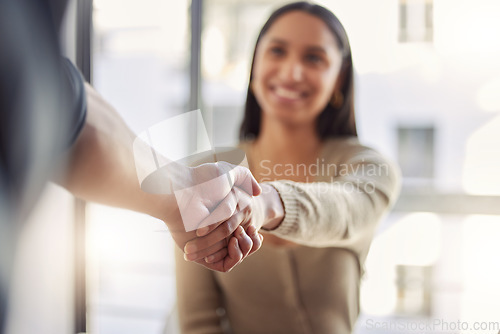 Image of Handshake, partnership and agreement with a business woman and colleague in an office for a meeting. Thank you, collaboration and trust with people shaking hands together in a corporate workplace