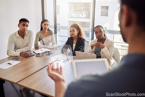 Image of Meeting, coaching and a business man with a tablet in the boardroom, talking to his team of colleagues. Workshop, presentation and teaching with a male manager in the office during a training seminar