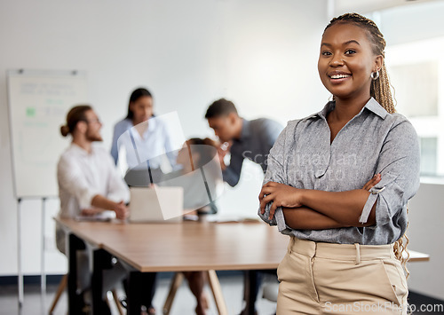 Image of Portrait, leadership and arms crossed with a business black woman in the office for a strategy meeting. Management, smile and a happy female leader standing in the workplace with a team of colleagues