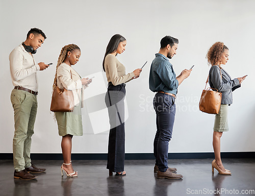 Image of Group, professional and cellphone standing in a line at a job interview at an agency or workplace. Business, people and waiting with mobile for job interview at a company for recruitment or hr.