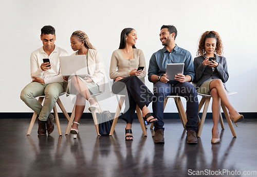 Image of Technology, hiring and recruitment with business people sitting in line waiting for a human resources meeting. Interview, online and talking with a happy candidate group in a row for a job vacancy