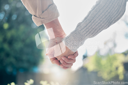 Image of Senior couple, holding hands and love in support, care or relationship in nature garden or park outdoors. Hand of elderly man and woman touching in loving romance, trust or partnership together