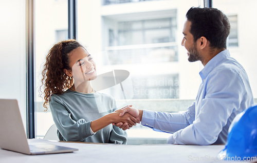 Image of Handshake, construction worker and woman or partner for business success, partnership or engineering deal in office. B2b, onboarding and architecture contractor or happy people shaking hands for job