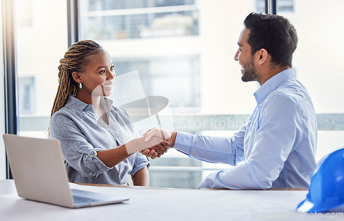 Image of Architecture, handshake and woman with partner for construction planning, thank you and success or deal in office. B2b, diversity and engineering meeting of contractor or happy people shaking hands