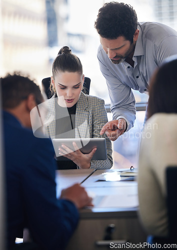 Image of Digital tablet, collaboration and team doing research together in a meeting in the office. Technology, professional and business people working on a corporate project in the workplace boardroom.