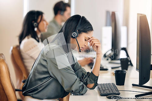 Image of Call center, stress and woman tired at computer for customer service, crm or telemarketing. Consultant or agent person with depression, headache and burnout for sales, contact us or help desk support