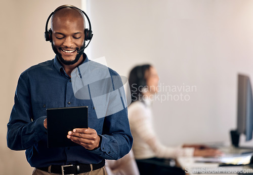 Image of Call center, tablet and man online for customer service, crm or telemarketing support. Black person, consultant or agent with a smile and technology for online sales, contact us or help desk advice