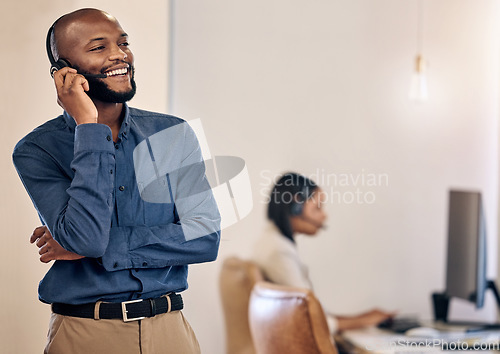 Image of Call center, laughing and man with headset for customer service, crm or telemarketing support. Black person, consultant or agent talking on microphone for sales, contact us or help desk space