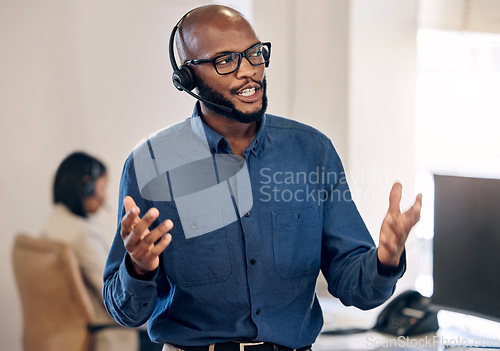 Image of Call center, talking and black man with headset for customer service, crm or telemarketing support. African person, consultant or agent talk on microphone for sales, contact us or help desk advice