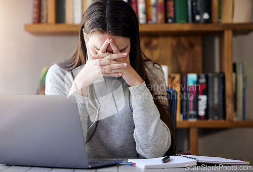 Image of Laptop, stress and education with a student woman feeling burnout while studying alone in her home. Learning, headache and tired with a young female university or college pupil in her house to study