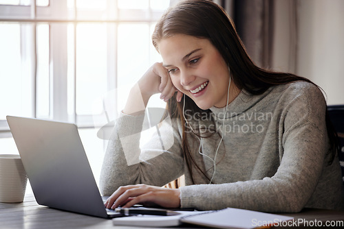 Image of Happy woman with laptop, earphones and video call at table in living room, elearning or webinar study. Smile, computer and college online class, girl with headphones at home for university education.