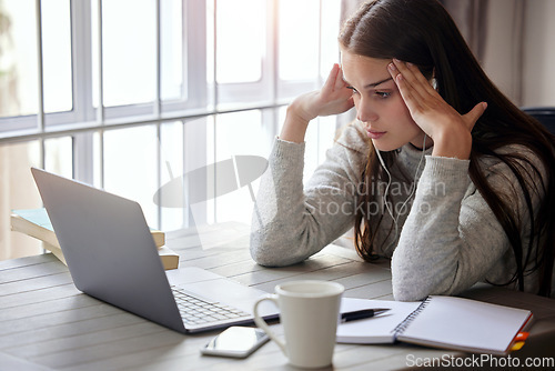 Image of Laptop, stress and learning with a student woman feeling burnout while studying alone in her home. Education, headache and tired with a young female university or college pupil in her house to study