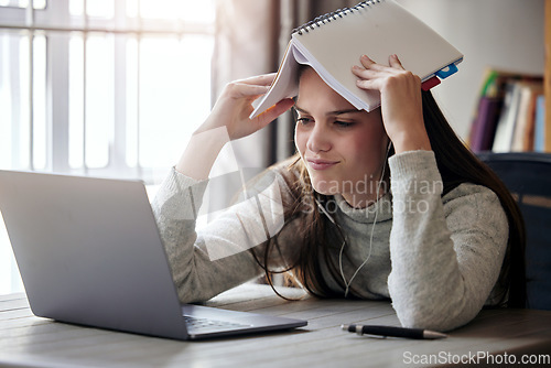 Image of Laptop, burnout and education with a student woman feeling stress while studying alone in her home. Learning, headache and exhausted with a female university or college pupil in her house to study